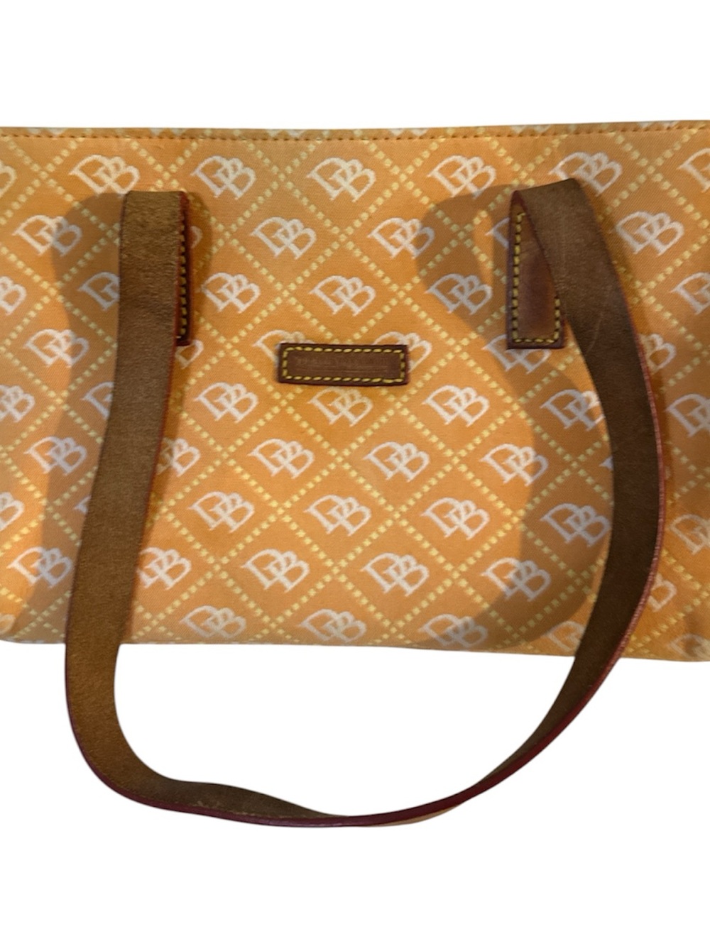 Dooney & Bourke orange with tan leather straps tote with gold hardware feet good
